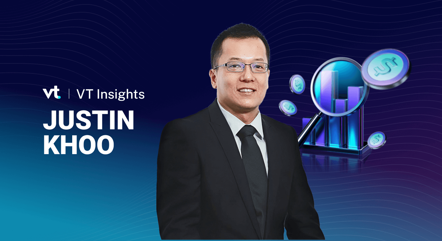 Portrait of a man in a black suit on a blue VT Insights banner with a 3D financial chart and coins.